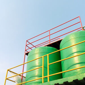 two-green-water-tanks-under-the-sky